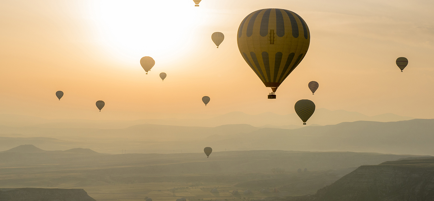 [Header] [About us] [International Development] Hot-air balloons at sunset